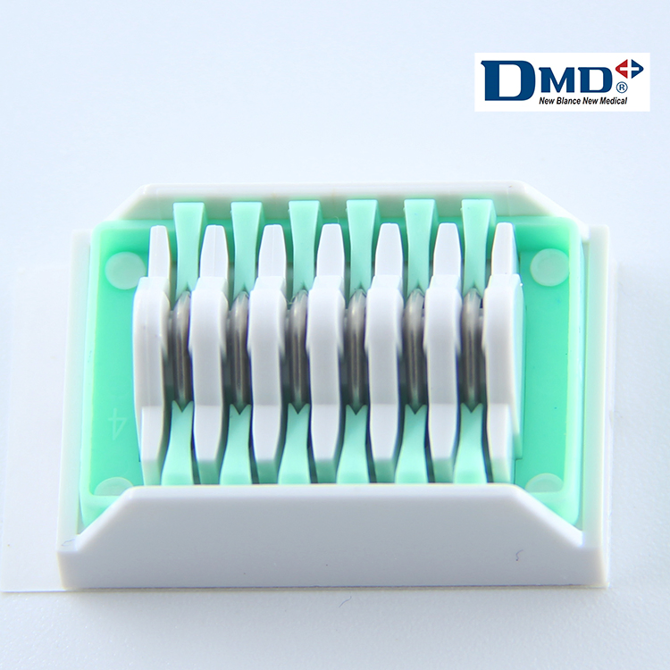 DMD TIGA-LOK titanium clip cartridge with green and white body — DMD manufacturer reference image; Vasculock packaging may differ